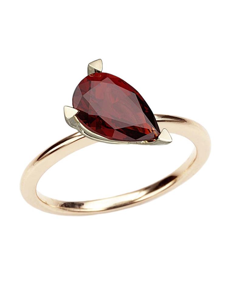 Octium ring in yellow gold with a large pear-cut garnet.